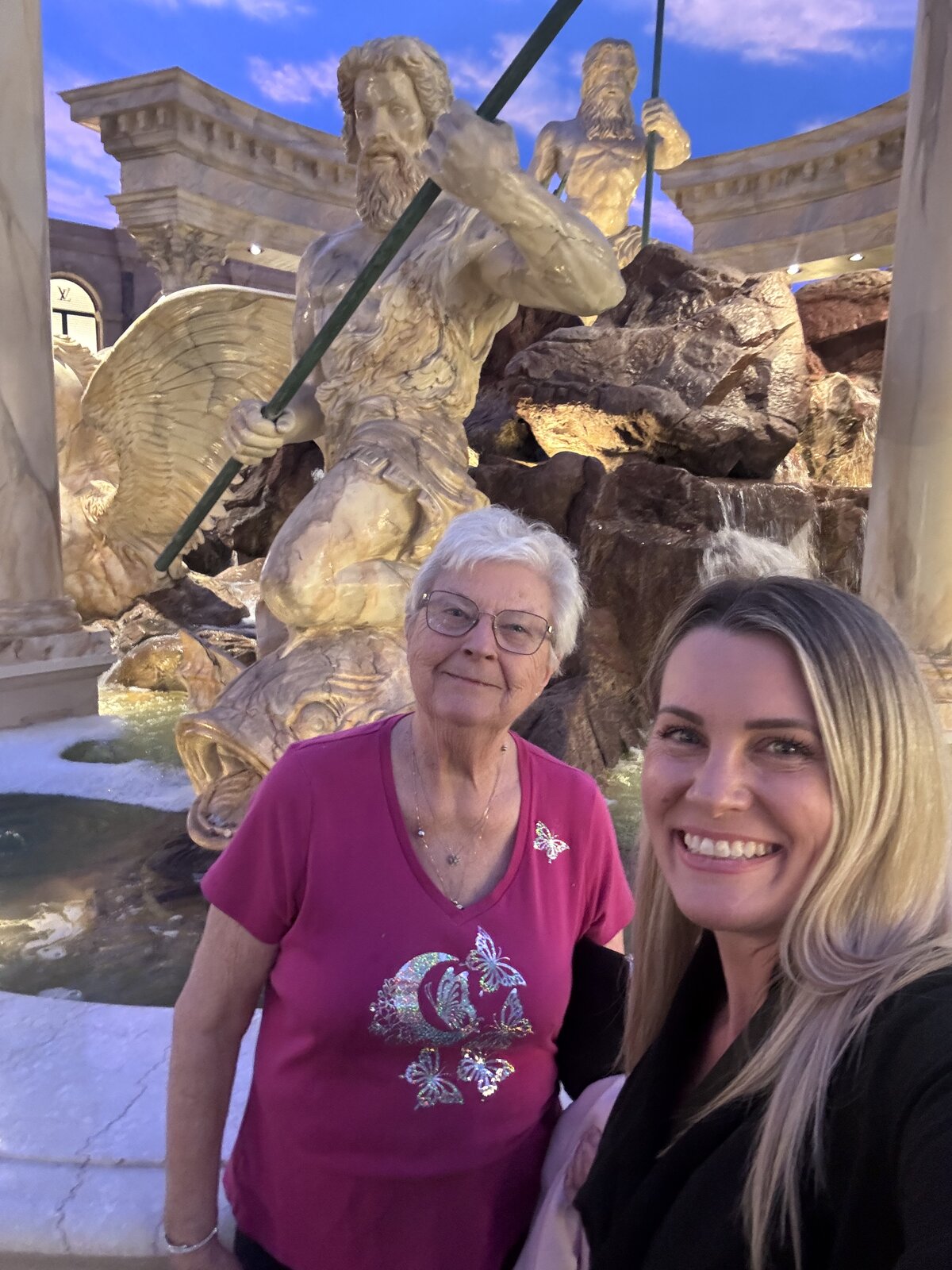 Grandmother and granddaughter posing in front of the Caesars Palace fountain in Las Vegas